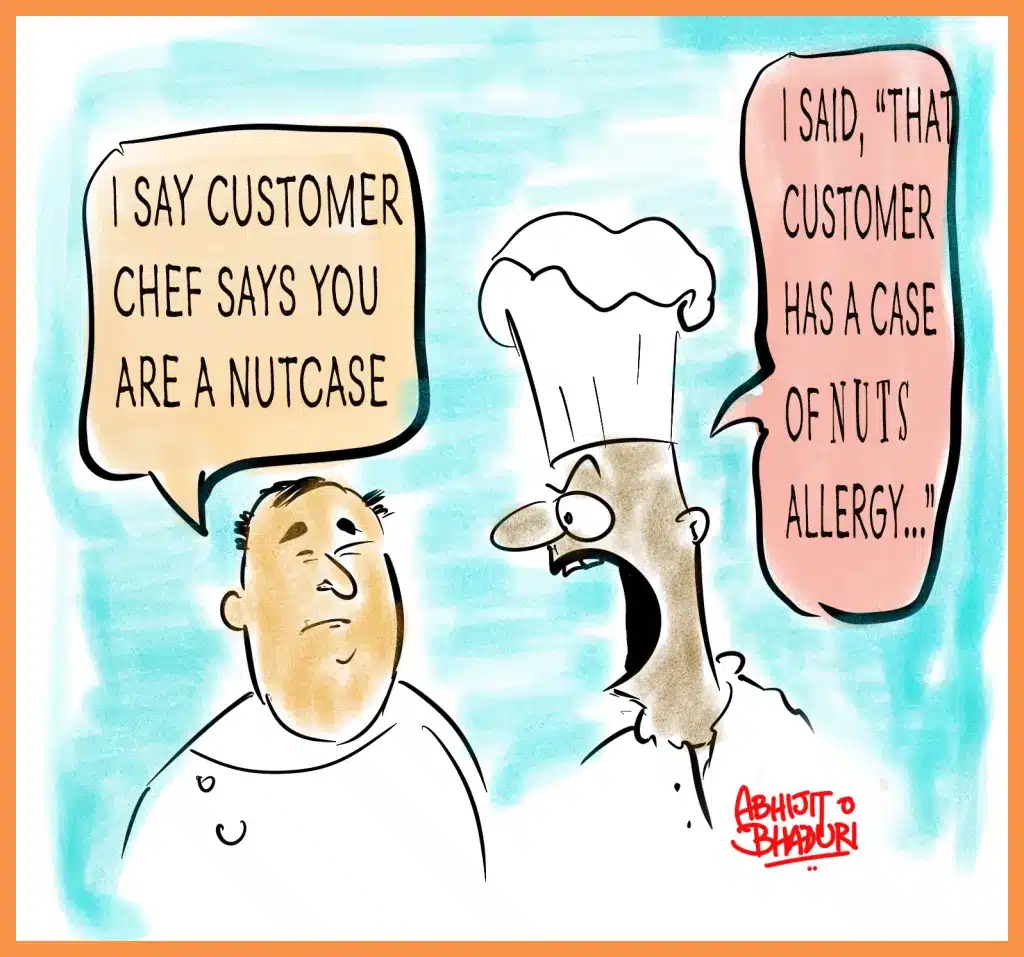 Cartoon of a chef and owner having a funny misunderstanding about nuts allergy. Reflects humor and communication challenges in India’s AI Revolution.